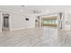 Open living room featuring tile flooring, ceiling fan, and sliding glass doors to the sunroom at 9777 Sw 63Rd Loop, Ocala, FL 34481