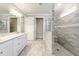 Elegant bathroom with double sink vanity, stylish tiled floor, and glass-enclosed shower at 9777 Sw 63Rd Loop, Ocala, FL 34481