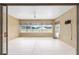 Large enclosed patio featuring a ceiling fan, ample windows and sliding glass door at 9777 Sw 63Rd Loop, Ocala, FL 34481