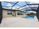 Backyard featuring a screened-in pool with a hot tub and covered patio with an umbrella at 9777 Sw 63Rd Loop, Ocala, FL 34481