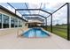 Backyard featuring a screened-in pool with a hot tub under an umbrella and spacious deck at 9777 Sw 63Rd Loop, Ocala, FL 34481