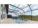 Backyard featuring a screened-in pool with a hot tub under an umbrella and spacious deck at 9777 Sw 63Rd Loop, Ocala, FL 34481