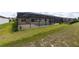 Backyard view of a screened in pool and patio in grassy yard at 9777 Sw 63Rd Loop, Ocala, FL 34481