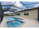 Inviting screened-in pool and spa area surrounded by a patio, perfect for outdoor relaxation and entertainment at 9777 Sw 63Rd Loop, Ocala, FL 34481