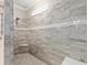 Modern tiled shower featuring a bench seat and elegant shower head at 9777 Sw 63Rd Loop, Ocala, FL 34481