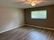 Comfortable bedroom with laminate floors, a window, and soothing neutral color scheme at 9801 Sw 88Th Ter # B, Ocala, FL 34481