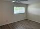 Bedroom with modern laminate flooring, neutral walls, and a bright window with blinds at 9801 Sw 88Th Ter # B, Ocala, FL 34481