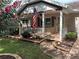 Charming front porch with American flag, white railings, and brick accents creates inviting curb appeal at 9801 Sw 88Th Ter # B, Ocala, FL 34481