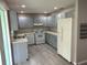 Functional kitchen featuring ample counter space, classic appliances, and muted blue cabinetry at 9801 Sw 88Th Ter # B, Ocala, FL 34481