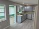 Well-lit kitchen with updated flooring, blue cabinets, and modern appliances at 9801 Sw 88Th Ter # B, Ocala, FL 34481