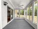 Bright sunroom with neutral carpet, multiple windows, and ceiling fan, creating a comfortable indoor-outdoor space at 10520 Sw 85Th Ter, Ocala, FL 34481