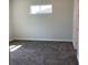 Cozy bedroom with neutral carpet, baseboards, and a window for natural light at 10540 Sw 49Th Avenue Rd, Ocala, FL 34476