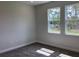 Bright bedroom with neutral carpet, baseboards, and two windows for natural light at 10540 Sw 49Th Avenue Rd, Ocala, FL 34476