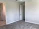 Bedroom featuring neutral carpet, baseboards, and an open doorway to another room at 10540 Sw 49Th Avenue Rd, Ocala, FL 34476