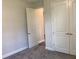 Bedroom featuring gray carpet, base trim, and white doors with neutral decor at 10540 Sw 49Th Avenue Rd, Ocala, FL 34476