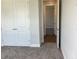 Bedroom with plush carpeting features a closet, a doorway, and neutral walls at 10540 Sw 49Th Avenue Rd, Ocala, FL 34476
