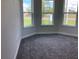 Cozy bedroom with plush carpet flooring and bright windows overlooking the neighborhood at 10540 Sw 49Th Avenue Rd, Ocala, FL 34476