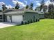New construction featuring a well manicured lawn, lovely shrubbery, and attached two-car garage at 10540 Sw 49Th Avenue Rd, Ocala, FL 34476