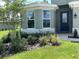 Charming front entry with bay window, a dark door, and verdant landscaping at 10540 Sw 49Th Avenue Rd, Ocala, FL 34476
