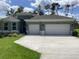 Charming single-story home with well-manicured lawn and a three-car garage on a sunny day at 10540 Sw 49Th Avenue Rd, Ocala, FL 34476