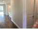 Hallway view leading to the kitchen, featuring laminate flooring and neutral wall tones at 10540 Sw 49Th Avenue Rd, Ocala, FL 34476