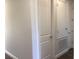 Bright hallway featuring white trim, doors, and neutral wall paint with wood-look flooring at 10540 Sw 49Th Avenue Rd, Ocala, FL 34476