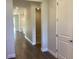 Neutral hallway with laminate flooring that connects to the kitchen and an adjacent bedroom at 10540 Sw 49Th Avenue Rd, Ocala, FL 34476
