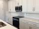 Bright kitchen features white cabinetry, quartz counters and stainless steel appliances at 10540 Sw 49Th Avenue Rd, Ocala, FL 34476