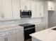 Bright kitchen features white cabinetry, quartz counters and stainless steel appliances at 10540 Sw 49Th Avenue Rd, Ocala, FL 34476