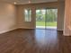 Bright living room with tile flooring and a large sliding glass door to backyard at 10540 Sw 49Th Avenue Rd, Ocala, FL 34476