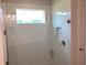 Elegant bathroom featuring a tiled shower with glass door and a window at 10540 Sw 49Th Avenue Rd, Ocala, FL 34476