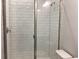 Tiled shower with glass doors and modern fixtures offers a clean and stylish bathroom space at 10540 Sw 49Th Avenue Rd, Ocala, FL 34476