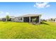 Well-maintained backyard features a grassy lawn and screened lanai at 10625 Sw 98Th Pl, Ocala, FL 34481