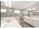 This bathroom features double sinks, and a large glass shower with a seat at 10625 Sw 98Th Pl, Ocala, FL 34481