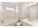 Bathroom features a combination shower and tub, a window and a single sink at 10625 Sw 98Th Pl, Ocala, FL 34481