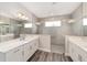 This bathroom features double sinks, and a large glass shower with a seat at 10625 Sw 98Th Pl, Ocala, FL 34481