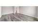 A bright, empty bedroom features grey wood flooring and neutral paint at 10625 Sw 98Th Pl, Ocala, FL 34481