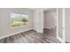 Bright bedroom features wood floors, large window and view of neighborhood at 10625 Sw 98Th Pl, Ocala, FL 34481