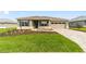 One-story home with a well-manicured lawn, paver driveway, and a two-car garage at 10625 Sw 98Th Pl, Ocala, FL 34481