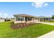 Landscaped front yard leading up to this beautiful home with an attached two car garage at 10625 Sw 98Th Pl, Ocala, FL 34481