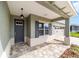Inviting entryway of a well-maintained home with a two-car garage and paved walkway at 10625 Sw 98Th Pl, Ocala, FL 34481