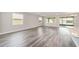 Spacious living room featuring wood-look floors, neutral walls, and ample natural light at 10625 Sw 98Th Pl, Ocala, FL 34481