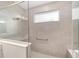 A tiled shower features a glass surround and built-in seating at 10625 Sw 98Th Pl, Ocala, FL 34481