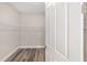 A walk-in closet features grey wood flooring and wire shelving at 10625 Sw 98Th Pl, Ocala, FL 34481