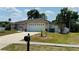 Charming single-story home features a two-car garage, manicured lawn, and inviting entryway at 1129 Wilmington Dr, Deltona, FL 32725