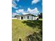Well-maintained backyard with ample green space, a modern home exterior, and a slider at 12282 Sw 80Th St, Dunnellon, FL 34432