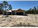This is a Cinder block house in the process of being built, with trees surrounding it in a construction site at 12282 Sw 80Th St, Dunnellon, FL 34432