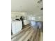Bright, open-concept kitchen with modern appliances, an island, and vinyl floors, perfect for Gathering gatherings at 12282 Sw 80Th St, Dunnellon, FL 34432
