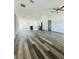 Spacious open floor plan with modern vinyl floors, featuring an integrated kitchen and abundant natural light at 12282 Sw 80Th St, Dunnellon, FL 34432