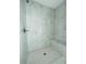 Shower with a bench, rainfall shower head, and hexagon tiled floor at 12282 Sw 80Th St, Dunnellon, FL 34432